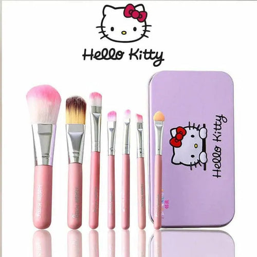 Set of pink makeup brushes with a Hello Kitty tin on a white background