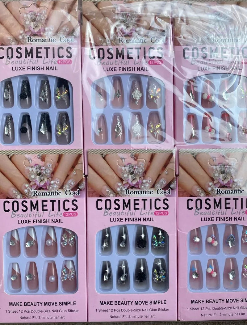 Multiple boxes of Romantic Cosmetics nail stickers with nail samples on a white background